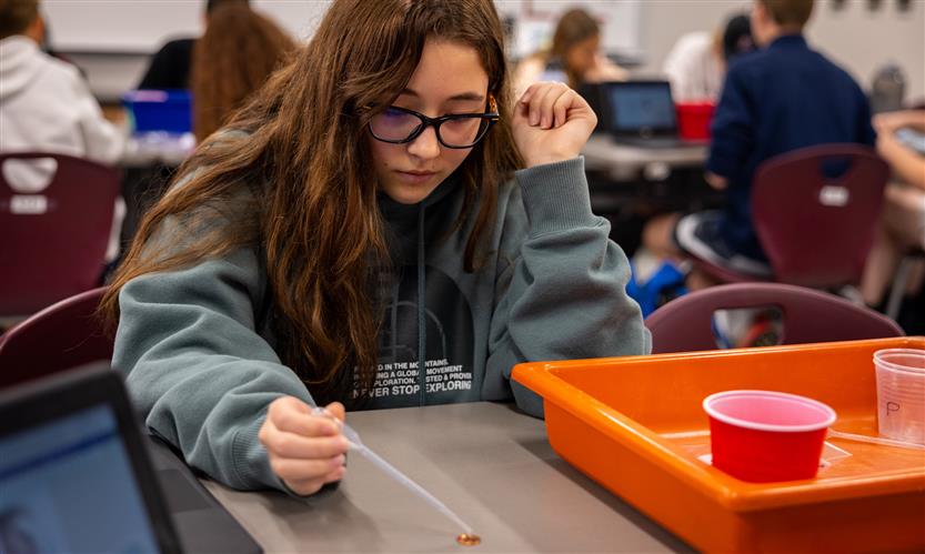 A girl drops water onto a penny